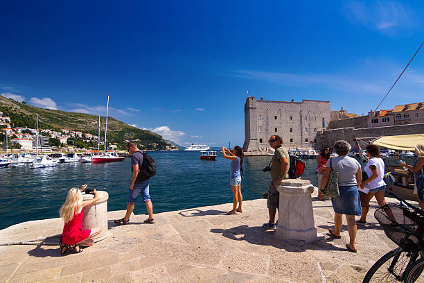 Dubrovnik, Croatia-August 19, 2014: A group of tourists in Old port, Dubrovnik, Croatia