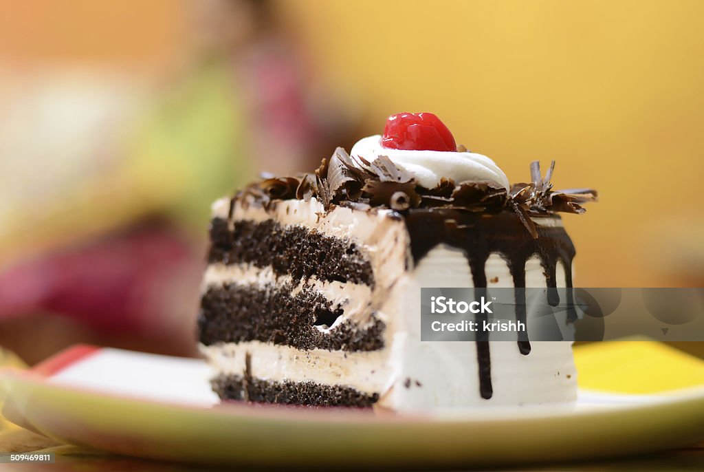 Slice of chocolate vanilla cake Dessert food - slice of chocolate vanilla cake in colorful background. Black Forest Cake Stock Photo