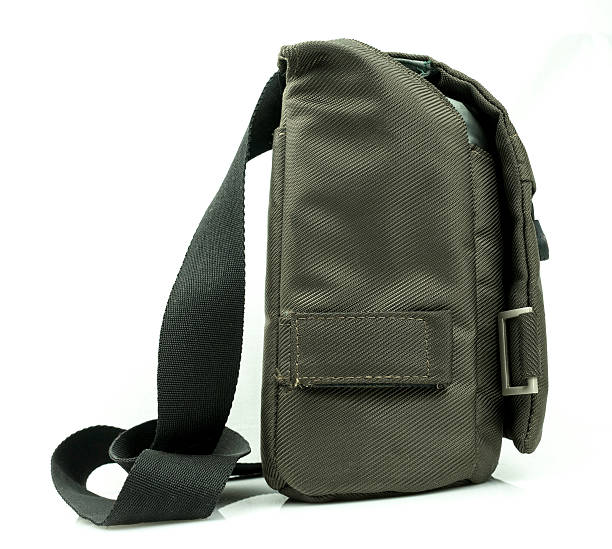 istock Small dark green sling bag on white background 509470409