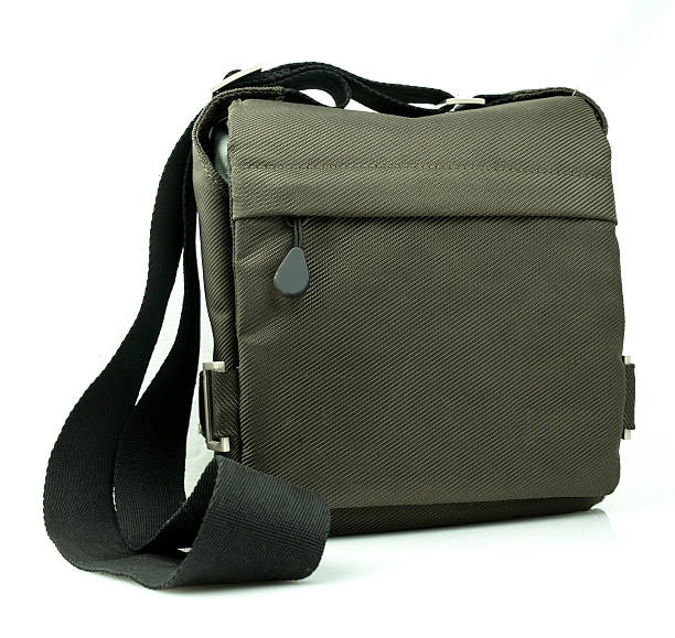 istock Small dark green sling bag on white background 509470417