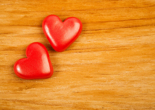 istock hearts on wooden background 509470869