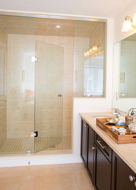 istock Frame-less glass shower stall in new bathroom 509471586