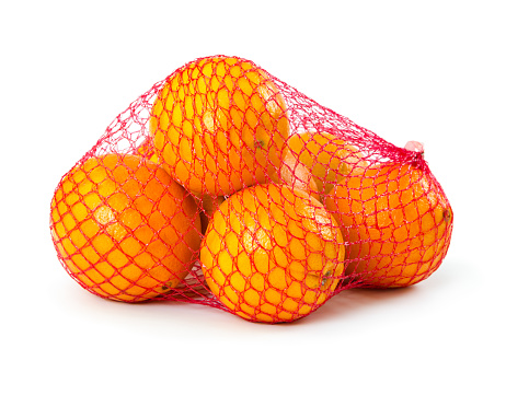 Fresh oranges in plastic mesh sack isolated on white background