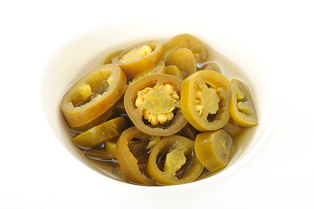 istock pickled sliced green jalapeno peppers in white bowl 509473782