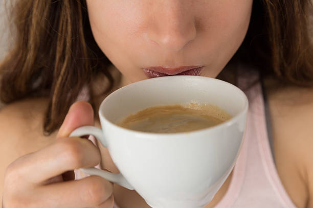 istock Woman drinking coffee close up 509474390