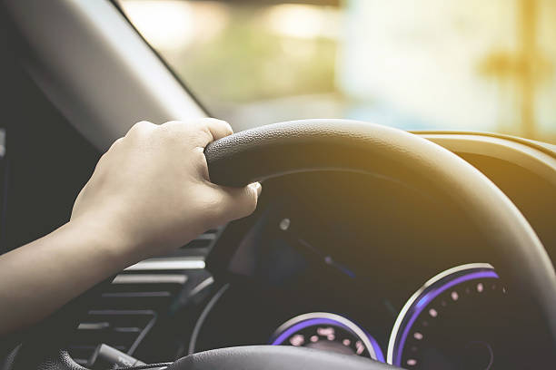 istock female driving car (left driver) 509475870