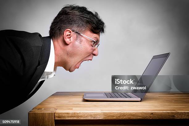 Man Screaming At Laptop Stock Photo - Download Image Now - Computer, Furious, Frustration