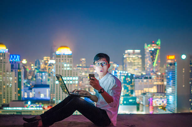 istock Businessman using a laptop on the rooftop of a skyscraper 509476396