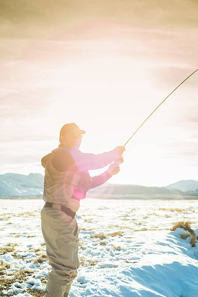 Winter Fly Fisherman Winter Fly Fisherman on the Owens River, California. owens river stock pictures, royalty-free photos & images