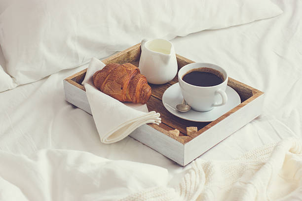 istock breakfast in bed,  tray with cup of coffee and  croissant 509478764