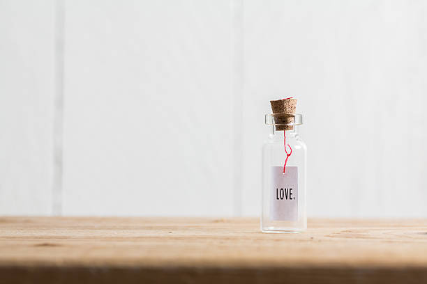 istock Love message in a bottle on wood table 509478892