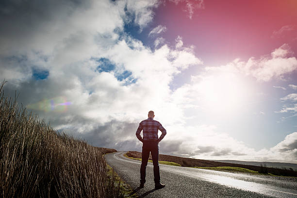 istock Man stood an open Country road 509478964
