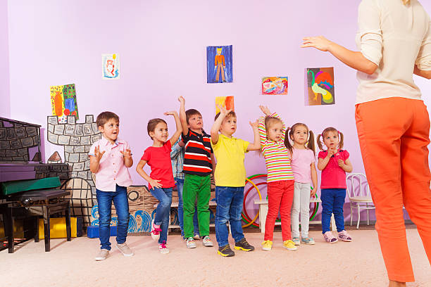 istock Group of kids repeating exercise after teacher 509481642