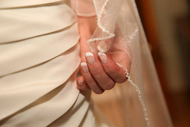 the bride is holding hand edge Bridal veils
