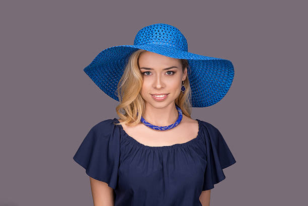 istock young woman isolated smiling in blue sun hat 509482060