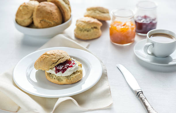 istock Scones with cream and fruit jam and cup of coffee 509483246