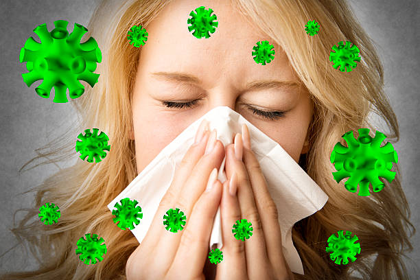 Ill woman with tissue is sneezing virus stock photo