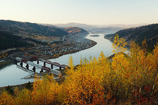 View on the railway bridge across the river from the forest stock photo