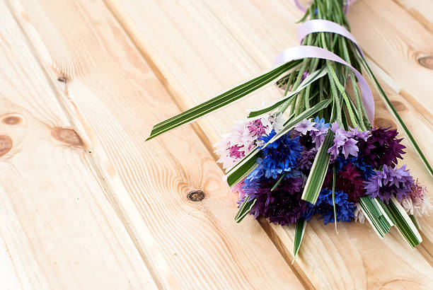 istock cornflowers flowers on a wooden background 509485740