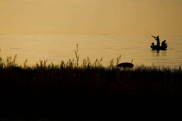 istock Fishermen fishing on beach during at sunset 509485808