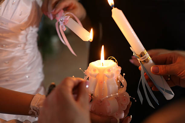 istock bride and groom light the wedding candle at the ceremony 509486600