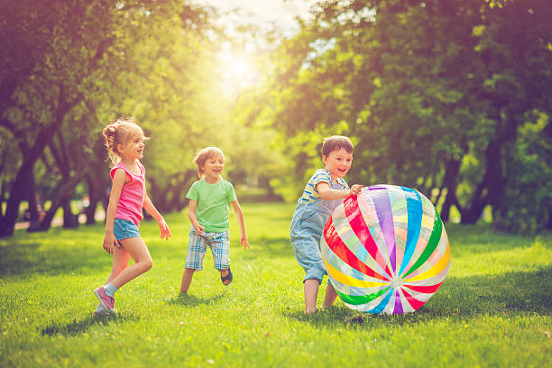 Happy children plating outdoors in summer