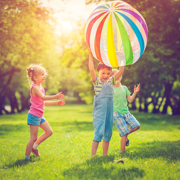 istock Little girl and boys playing with ball 509486890