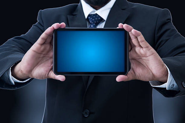 istock Man's hands holding a tablet PC displaying business Concepts 509487464