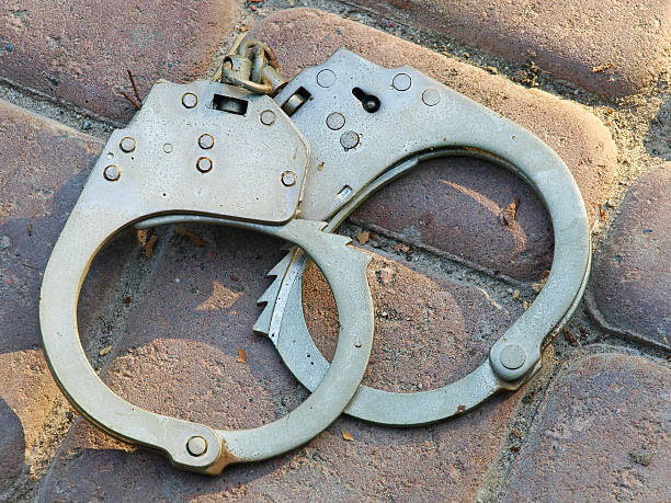 istock Handcuffs on a stone floor tiles. 509487693