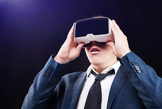 Businessman using his Virtual Reality VR glasses head mounted display