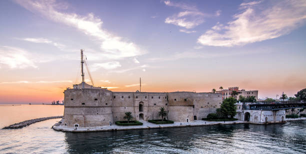 Taranto, Puglia, Italy Taranto, Italy. August 10, 2014. The Aragonese Castle, the main fortification of the city of Taranto. inlet photos stock pictures, royalty-free photos & images