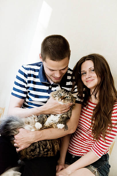 istock happy young couple with their cat 509490063
