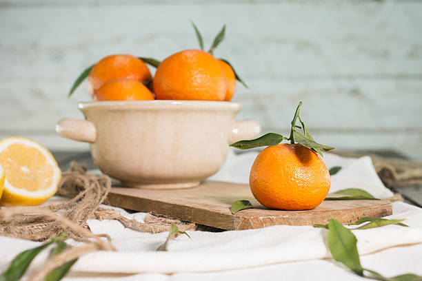 istock Mandarins and lemon on wooden table 509491822