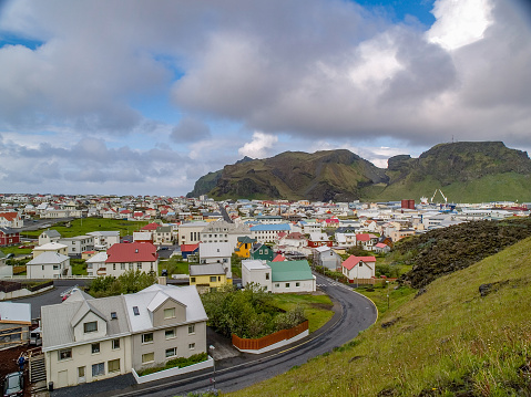 Cluster of houses in front of mountain at Heimaey, Vestmannaeyjar, Iceland. Also known as The Westman Islands.