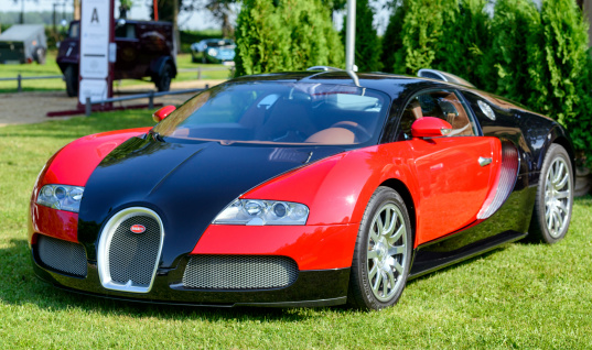 Jüchen, Germany - August 1, 2014: Red and black Bugatti Veyron hypercar on display during the 2014 Classic Days event at Schloss Dyck.
