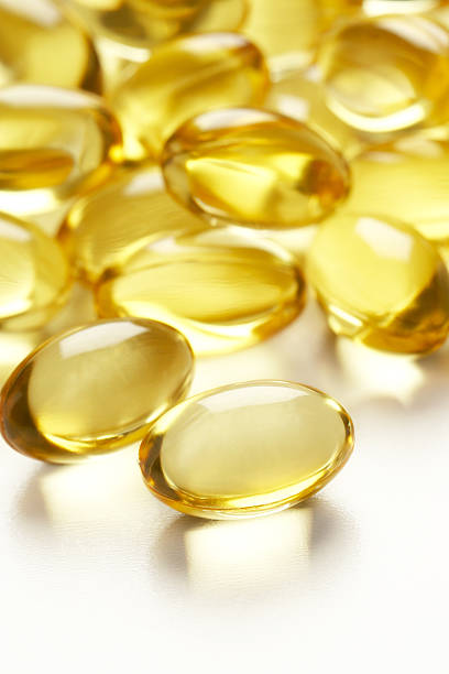 Gel Pills Gel Pills cod liver oil fish oil vitamin a pill stock pictures, royalty-free photos & images