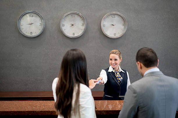 istock Woman working at a hotel doing the check in 509493618