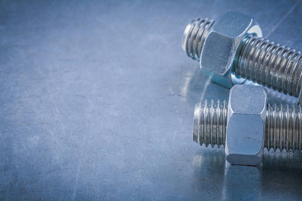 istock Pair of threaded bolts construction nuts on metallic background 509496524