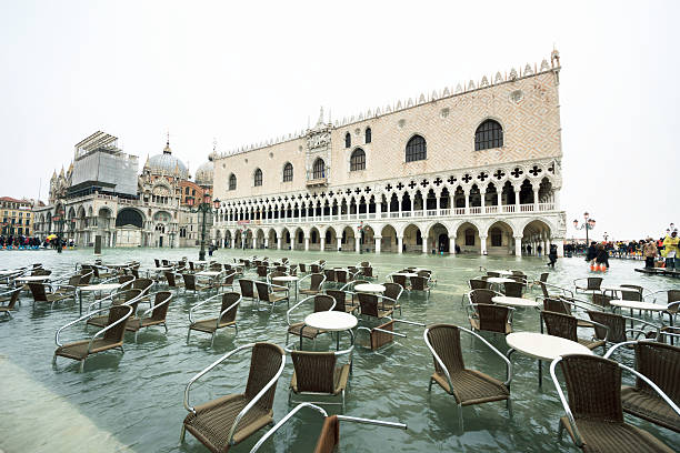 Venice, St Mark's square flooded from the high water Venice, Italy - February 6, 2015: Venice, St Mark's square flooded from the high water. high tide stock pictures, royalty-free photos & images