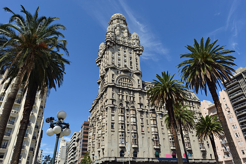 Palm trees and old Art-Deco buildings near Plaza Indepedencia, Montevideo, Uruguay.