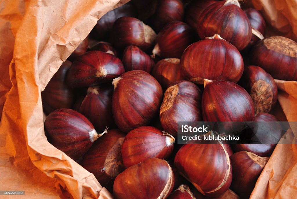 Roasted chestnuts ready to eat on crafted paper. Roasted chestnuts ready to eat on crafted paper Autumn Stock Photo