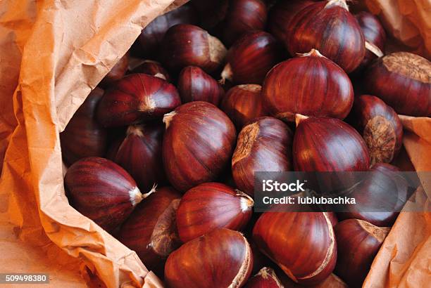 Roasted Chestnuts Ready To Eat On Crafted Paper Stock Photo - Download Image Now - Autumn, Brown, Chestnut - Food