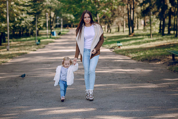 istock young family walking in the park 509498694