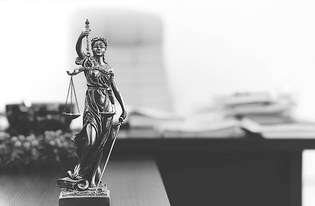 Themis statue in lawyer's office Themis statue on the table in lawyer's office in black and white. lady justice photos stock pictures, royalty-free photos & images