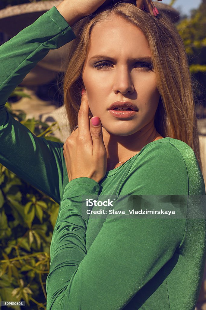 portrait of beautiful girl with blond hair in elegant dress fashion photo of beautiful model with short blond hair wearing luxurious green dress Adult Stock Photo