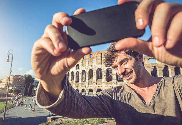 istock Man taking a selfie in front of the Coliseum 509511633