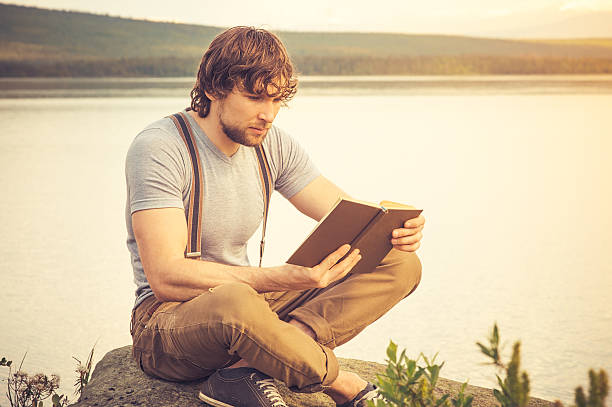 istock Young Man reading book outdoor Lifestyle 509512057