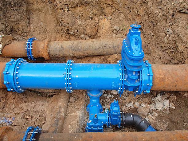 istock Old big drink water pipes joined with new blue valves 509514553