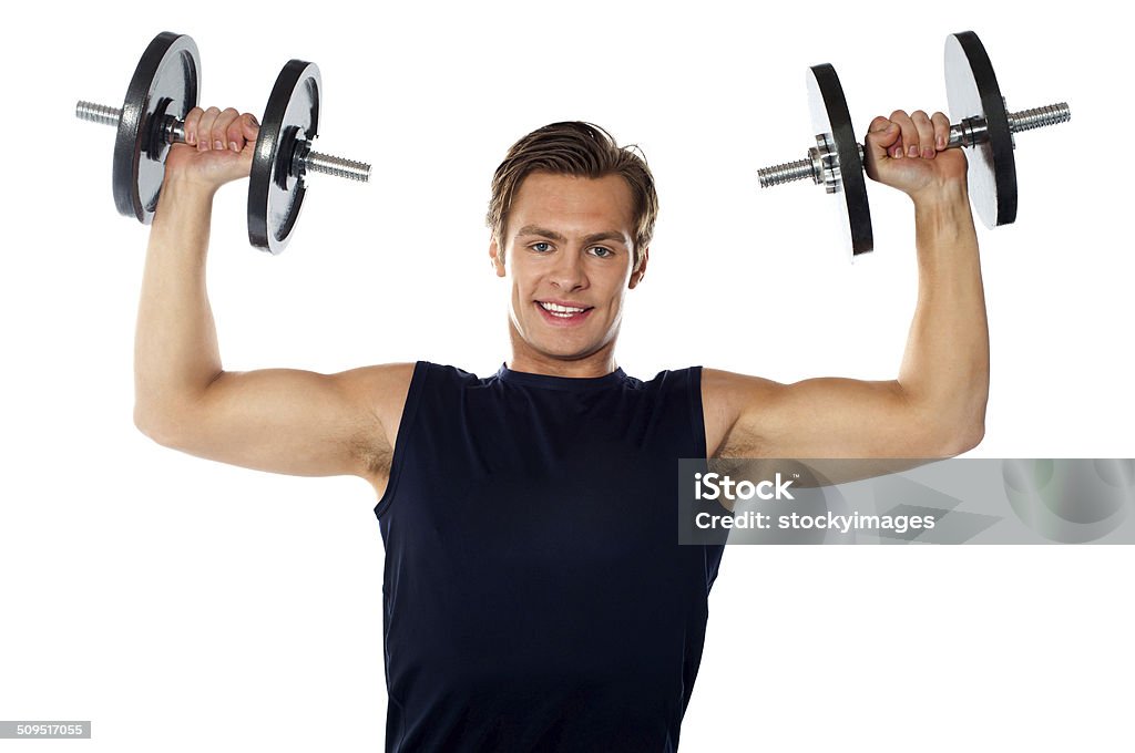 Caucasian athlete exercising in sporty outfits Caucasian athlete exercising in sporty outfits, lifting weights Adults Only Stock Photo