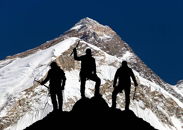 istock Everestand silhouette of three climbing men with ice axe 509529770